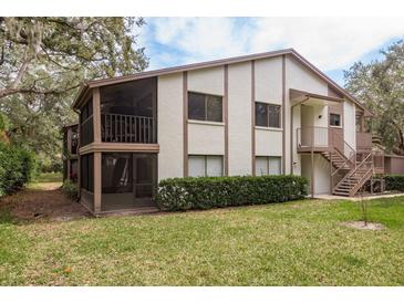 Charming two-story condo with private screened balcony, lush green lawn, and nicely maintained landscaping at 515 Mistletoe Ct # C, Safety Harbor, FL 34695