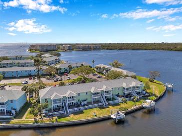 Waterfront condo community with lush landscaping and boat docks on a sunny day at 5152 Salmon Se Dr # C, St Petersburg, FL 33705