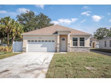 Charming single-story home featuring a two-car garage and stone accents at 5361 71St N Way, St Petersburg, FL 33709