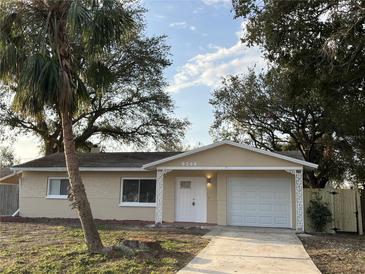 Charming single-story home featuring a well-maintained front yard, a driveway and an attached garage at 9346 52Nd Way, Pinellas Park, FL 33782