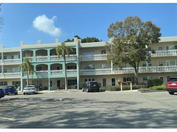 Multi-story building featuring balconies and well-maintained landscaping at 2330 Ecuadorian Way # 10, Clearwater, FL 33763