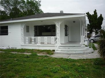 Charming home featuring a covered front porch with decorative columns and railings at 2414 E 8Th Ave, Tampa, FL 33605