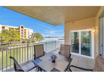 Relax on the balcony with waterfront views, perfect for dining and entertaining near sliding glass doors at 399 150Th Ave # 101A, Madeira Beach, FL 33708