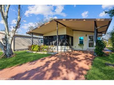 Charming single-story home featuring a covered porch, landscaped yard, and cozy curb appeal at 411 Dolphin S Dr, Oldsmar, FL 34677