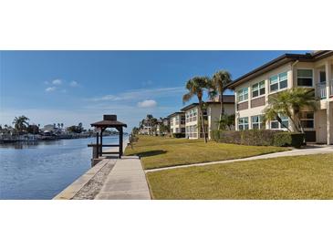 Scenic waterfront view, with buildings lining the waterway, palm trees, and a gazebo at 4812 Jasper Dr Dr # 101, New Port Richey, FL 34652