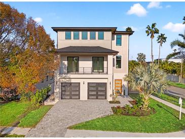 This modern two-story home features a two-car garage, front balcony, and a beautifully landscaped yard at 531 Danube Ave, Tampa, FL 33606