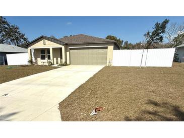 Charming one-story home featuring a large driveway and well-maintained front yard at 9377 Benrock Rd, Spring Hill, FL 34608