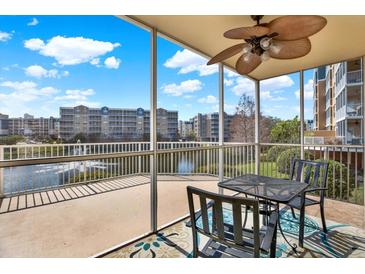 Relaxing screened patio with a ceiling fan offers a stunning view of the waterfront and fountain at 960 Starkey Rd # 3106, Largo, FL 33771