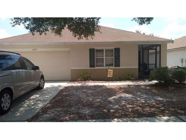 Charming single-story home with a tidy front yard, attached garage, and screened porch at 10933 Subtle Trail Dr, Riverview, FL 33569