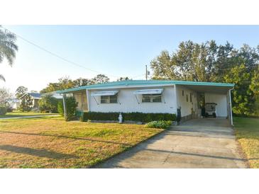 Charming single-story home with a covered carport and well-maintained front lawn at 221 Philadelphia Blvd # 32, Palm Harbor, FL 34684