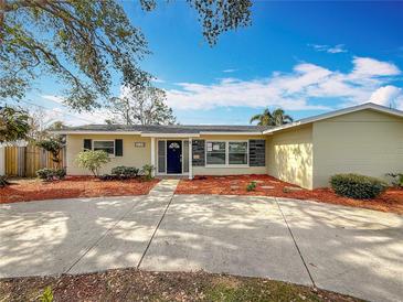 Charming single-story home with a well-maintained front yard, vibrant landscaping, and a welcoming entrance at 3124 61St N Ln, St Petersburg, FL 33710