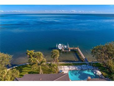 Panoramic aerial view of a waterfront property featuring a private dock, boats, and swimming pool at 6620 Colony S Dr, St Petersburg, FL 33705