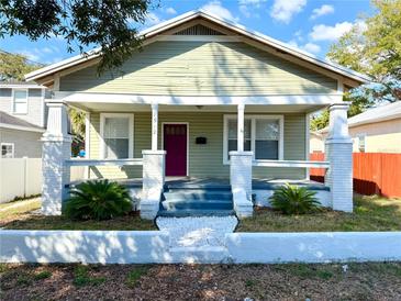 Charming single-story home features a welcoming porch and manicured front yard at 1312 E 19Th Ave, Tampa, FL 33605