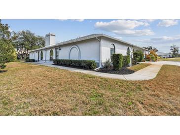 Charming exterior view of a well-maintained home with unique architectural details and manicured landscaping at 23227 Club Villas Dr # 38, Land O Lakes, FL 34639