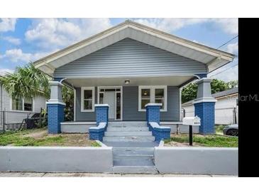 Charming craftsman-style home featuring blue and gray painted finishes, a welcoming front porch, and well-manicured landscaping at 3017 Sanchez St # 1/2, Tampa, FL 33605