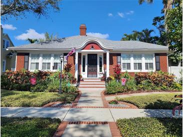 Charming brick home with a manicured front yard, walkway, and beautiful landscaping at 635 13Th Ne Ave, St Petersburg, FL 33701