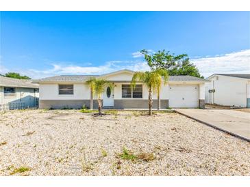 Charming single-story home featuring a well-manicured, low maintenance front yard and attached garage at 7635 Sue Ellen Dr, Port Richey, FL 34668