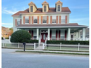 Charming two-story home with a front porch and white picket fence at 8137 Cottonwood Ct, Seminole, FL 33776