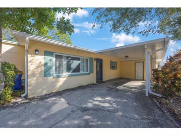 Charming home featuring covered parking, a well-maintained yard, and a welcoming front entrance at 10373 54Th N Ave, St Petersburg, FL 33708