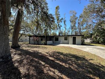 Charming single-story home with mature trees, large front yard and a driveway, perfect for Gathering living at 1501 Howard Pl, Largo, FL 33770