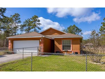 Charming single Gathering home featuring a two-car garage and manicured lawn at 15429 Green Jay Rd, Weeki Wachee, FL 34614