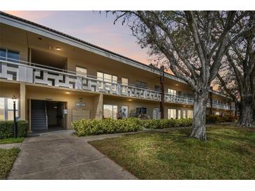 Well-maintained condo building with lush landscaping, offering a serene community setting at 2280 World Parkway Blvd # 34, Clearwater, FL 33763