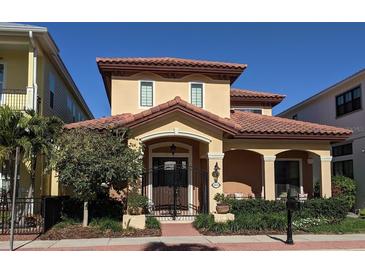 Charming two-story home featuring a terracotta roof, arched entry, and manicured landscaping at 249 Iron Age St., Safety Harbor, FL 34695