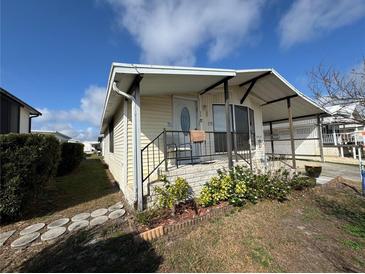 Charming single-story home featuring a cozy porch, landscaped yard, and covered carport for convenient parking at 4747 Bobby Ave # 258, Zephyrhills, FL 33541