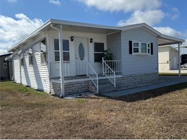 Charming single-story home with a covered porch and well-maintained facade at 4845 Baker Ave, Zephyrhills, FL 33541