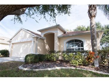 Charming single-story home featuring a well-manicured lawn and an attached two-car garage at 5011 Glenburne Dr, Spring Hill, FL 34609