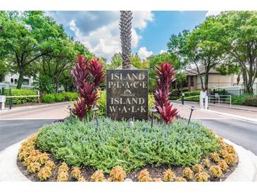 Landscaped entrance to Island Place and Island Walk with stone signage and well-maintained greenery at 628 Arbor Lake Ln, Tampa, FL 33602