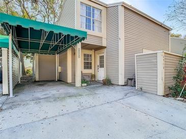 Charming townhome featuring a covered carport, neutral siding, and a welcoming front entrance at 6910 Lake Place Ct, Tampa, FL 33634