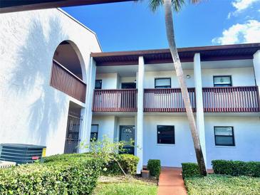 Charming condo featuring balconies, a well-maintained lawn, and classic architectural details at 7623 Radcliffe Cir # 211A, Port Richey, FL 34668