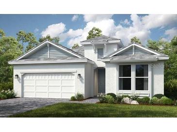 Charming single Gathering home displaying a two car garage, neutral colors, and lush green landscaping at 26836 Dove Dr, Punta Gorda, FL 33955
