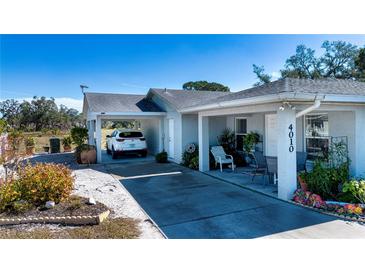 Well-maintained home with two carports, a spacious driveway, and a nicely landscaped front yard at 4010 N Lockwood Ridge Rd, Sarasota, FL 34234