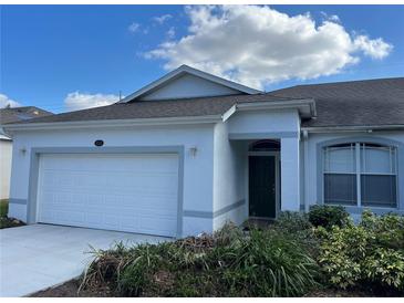 Well-maintained single-Gathering home with a two-car garage and manicured front yard at 8019 Brien Green Way, Temple Terrace, FL 33637