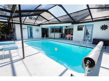 Relaxing pool area with a screened enclosure, offering both sun and shade for comfortable outdoor living at 8979 Hernando Way, Weeki Wachee, FL 34613