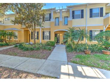 Charming two-story townhome with a landscaped front yard and inviting entryway at 7570 Tamarind Ave, Tampa, FL 33625