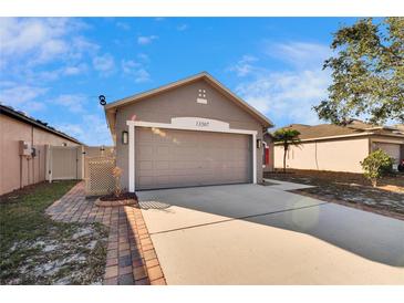 Single Gathering home with a two-car garage and neutral toned exterior at 13507 Mango Bay Dr, Riverview, FL 33579