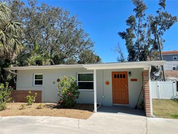 Charming single-story home with a vibrant orange front door and well-maintained landscaping at 2656 44Th S St, Gulfport, FL 33711