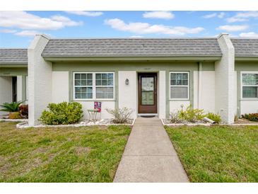 Charming single-story home featuring a well-manicured lawn and inviting front entrance at 4647 Lake Villa Dr, Clearwater, FL 33762