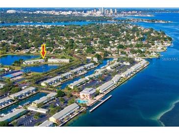 Stunning aerial view of waterfront condos with boat docks and serene lake views in a vibrant community at 4816 Snook Se Dr # A, St Petersburg, FL 33705