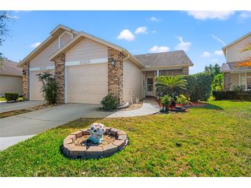 Charming single-story home featuring a one car garage, well-maintained lawn, and lovely landscaping at 6428 Thicket Trl, New Port Richey, FL 34653