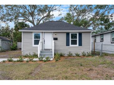 Charming home featuring gray siding, dark roof, and neatly landscaped front yard at 1931 24Th S St, St Petersburg, FL 33712