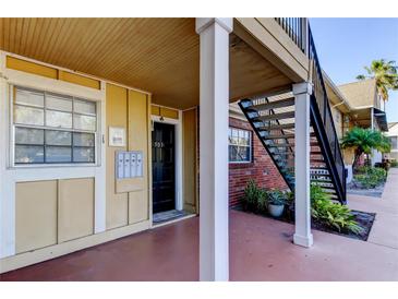 Condo exterior featuring a covered porch and staircase to the upper level at 200 Country Club Dr # 503, Largo, FL 33771