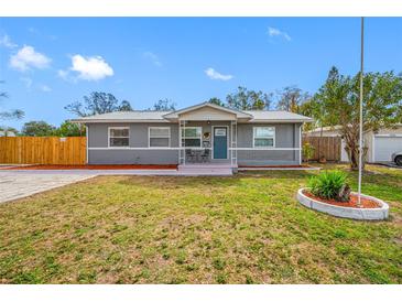 Charming single-story home with a well-manicured lawn and inviting blue front door at 3166 13Th N Ave, St Petersburg, FL 33713