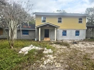 Two-story home with a covered entry and partially completed exterior at 4004 27Th Se St, Ruskin, FL 33570