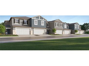 Stylish townhomes featuring attached garages and modern architectural details in a well-manicured community at 9304 Bonita Mar Dr, Parrish, FL 34219