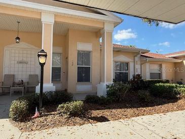 Charming home featuring a light exterior, well-maintained landscaping, and inviting front porch at 108 Knollpoint Dr, Sun City Center, FL 33573