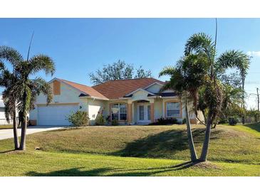 Inviting single-story home with manicured lawn and lush palm trees at 9350 Gulfstream, Englewood, FL 34224